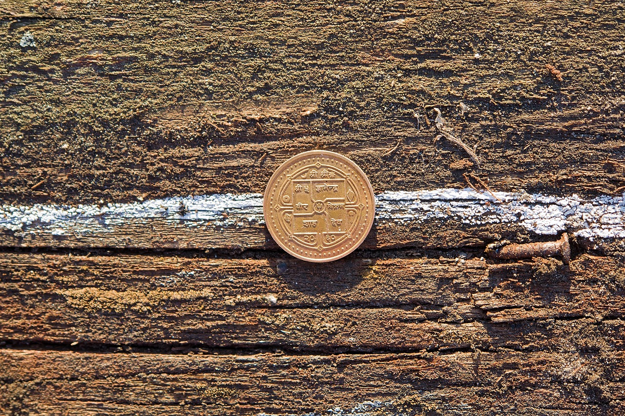 Money, coin, table — How Finance Knowledge Can Reduce Debt Stress