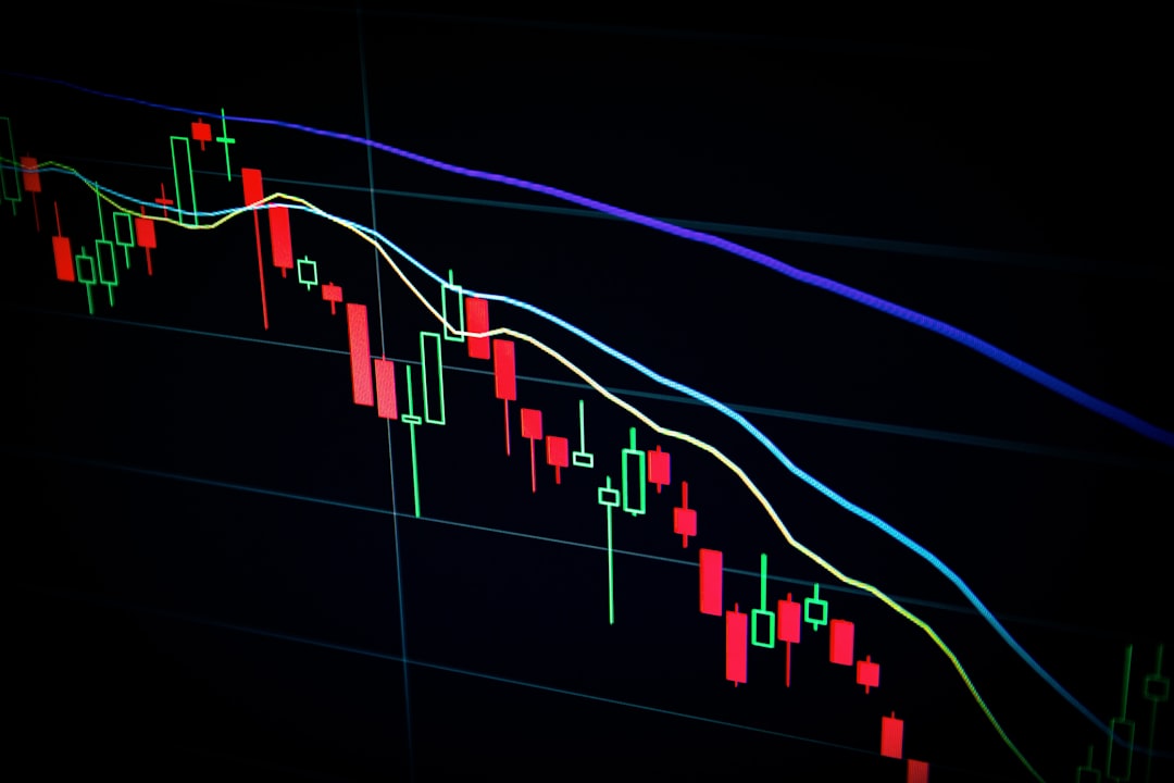 Close-up of a stock market candlestick chart displaying fluctuating prices in various colors against a dark background.